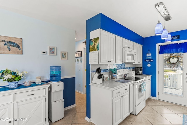 kitchen with hanging light fixtures, tasteful backsplash, white cabinets, white appliances, and light tile patterned floors