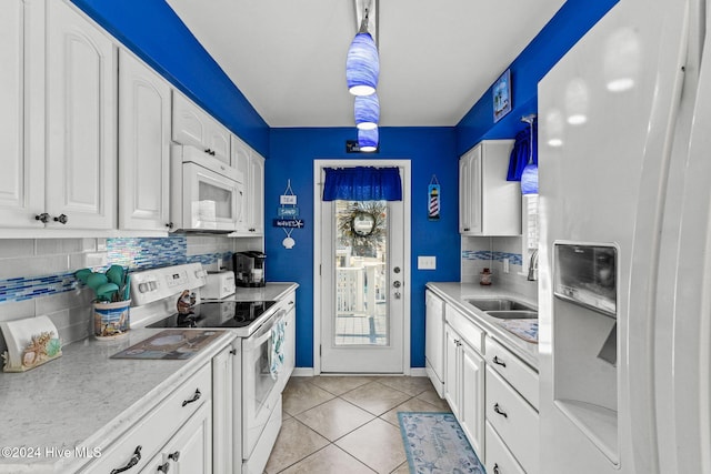 kitchen featuring pendant lighting, white appliances, white cabinetry, and sink