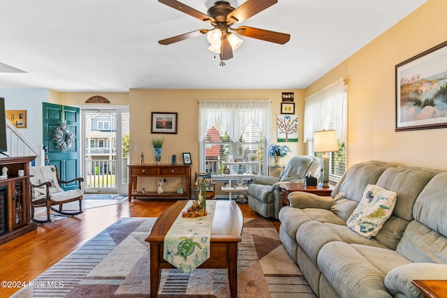 living room featuring ceiling fan and hardwood / wood-style floors