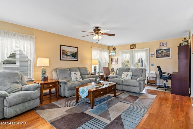 living room featuring ceiling fan and wood-type flooring