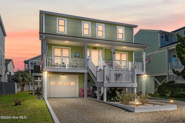 view of front facade featuring covered porch and a garage