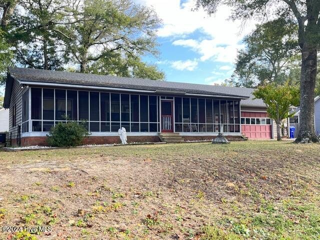 view of front facade with a sunroom