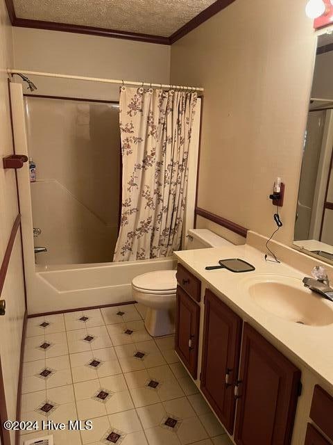 full bathroom featuring tile patterned floors, a textured ceiling, ornamental molding, vanity, and shower / bathtub combination with curtain