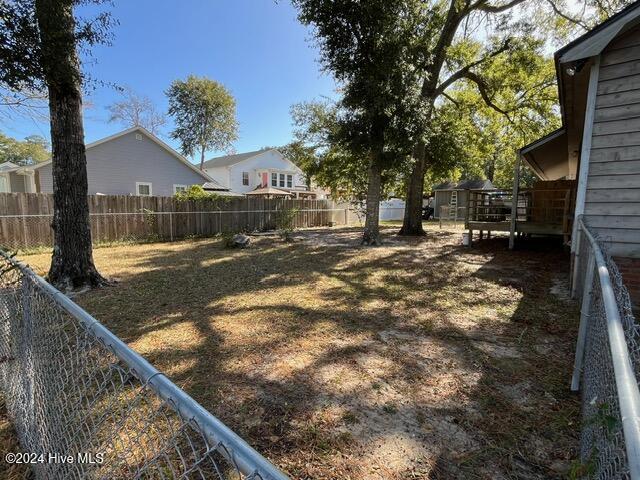 138 NW 17th St, Oak Island, NC 28465 - fenced backyard with an outdoor structure