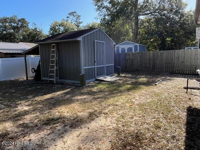 138 NW 17th St, Oak Island, NC 28465 - view of shed with a fenced backyard
