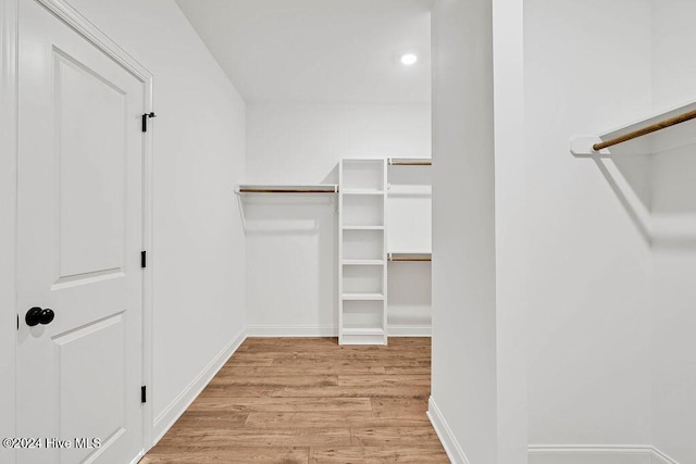 walk in closet featuring light hardwood / wood-style floors