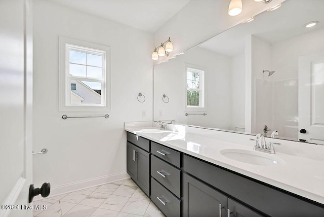 bathroom with walk in shower, plenty of natural light, vanity, and toilet