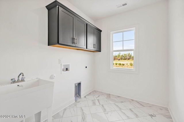 clothes washing area featuring cabinets, hookup for a washing machine, electric dryer hookup, sink, and hookup for a gas dryer