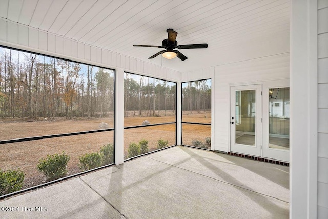 unfurnished sunroom featuring ceiling fan