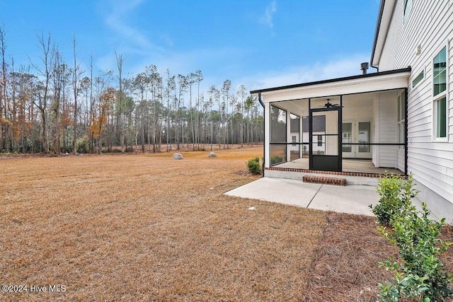 view of yard featuring a sunroom and a patio