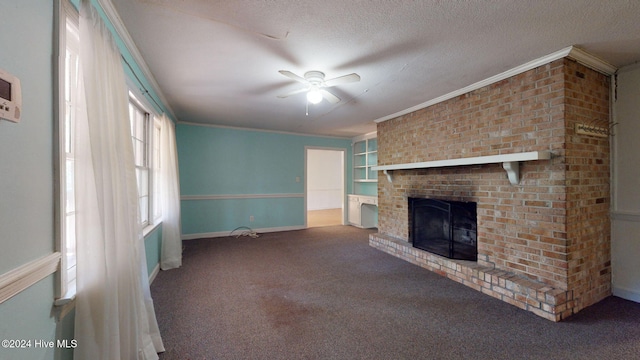 unfurnished living room featuring carpet flooring, a brick fireplace, a textured ceiling, ceiling fan, and crown molding