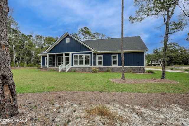 rear view of house with a lawn