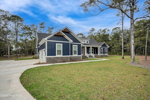 craftsman house with a front yard, a porch, and a garage