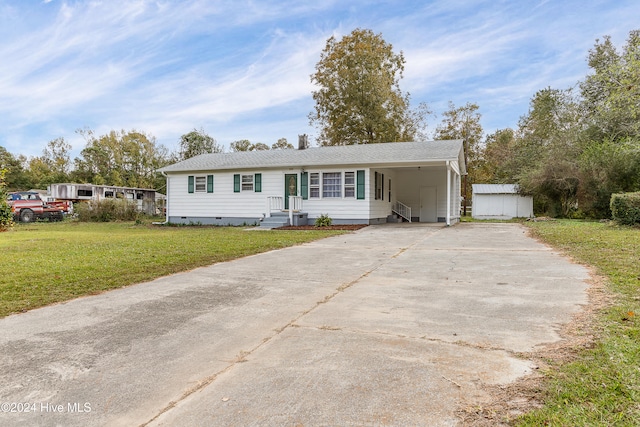 view of front of home with a front lawn and a carport