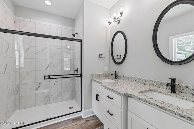 2013 E Hawthorne St, Goldsboro, NC 27530 - bathroom with double vanity, a stall shower, wood finished floors, and baseboards