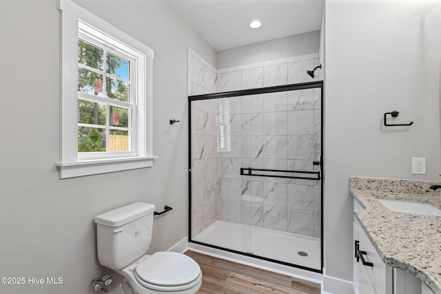 2013 E Hawthorne St, Goldsboro, NC 27530 - full bath with toilet, a shower stall, vanity, wood finished floors, and baseboards
