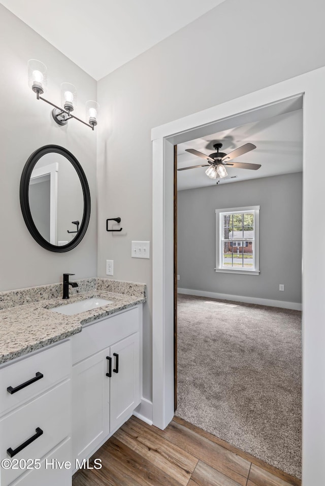 2013 E Hawthorne St, Goldsboro, NC 27530 - bathroom with vanity, ceiling fan, baseboards, and wood finished floors