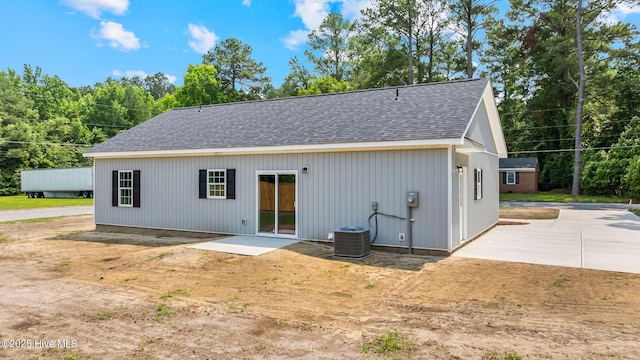 2013 E Hawthorne St, Goldsboro, NC 27530 - rear view of house featuring roof with shingles, central air condition unit, a patio, and dirt driveway