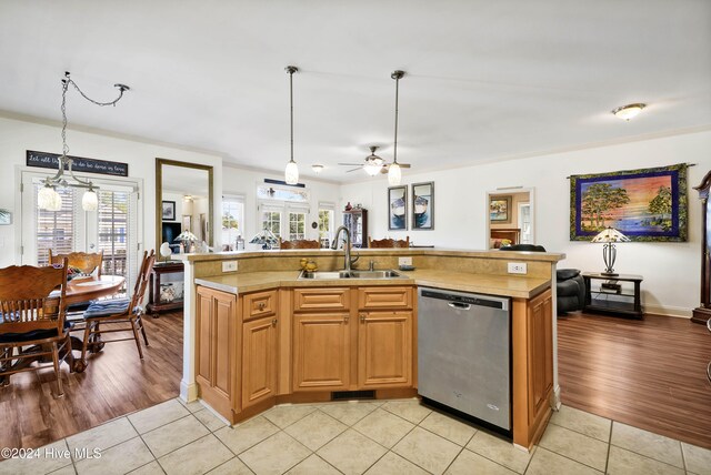 kitchen with dishwasher, light wood-type flooring, a center island with sink, and sink