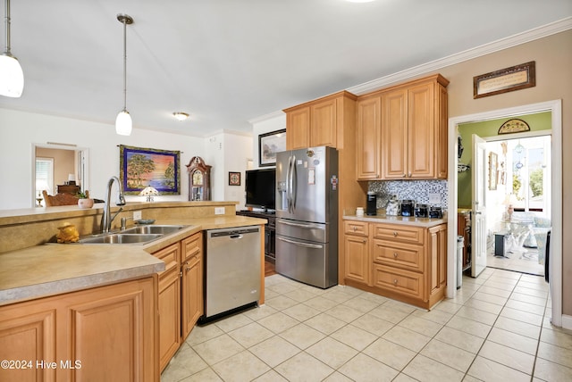 kitchen featuring appliances with stainless steel finishes, crown molding, pendant lighting, and sink