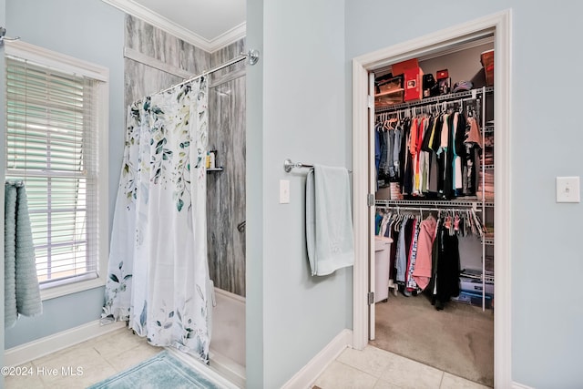 bathroom featuring crown molding, tile patterned flooring, and a shower with shower curtain