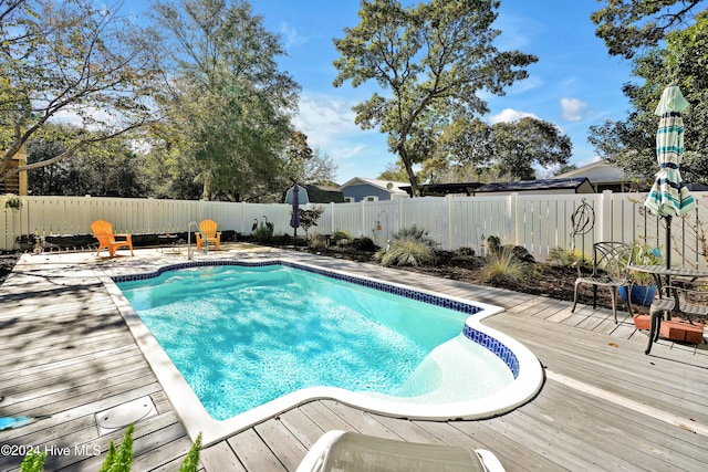 view of swimming pool featuring a wooden deck