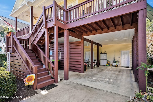 view of patio with ceiling fan and a deck