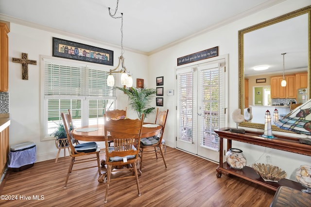 dining area featuring crown molding, a healthy amount of sunlight, and wood-type flooring