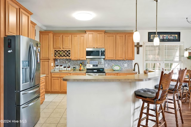 kitchen with pendant lighting, crown molding, light tile patterned floors, tasteful backsplash, and stainless steel appliances