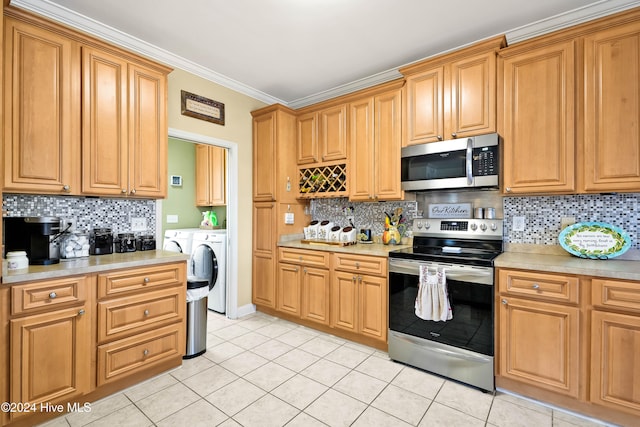 kitchen with decorative backsplash, appliances with stainless steel finishes, light tile patterned flooring, and washing machine and clothes dryer