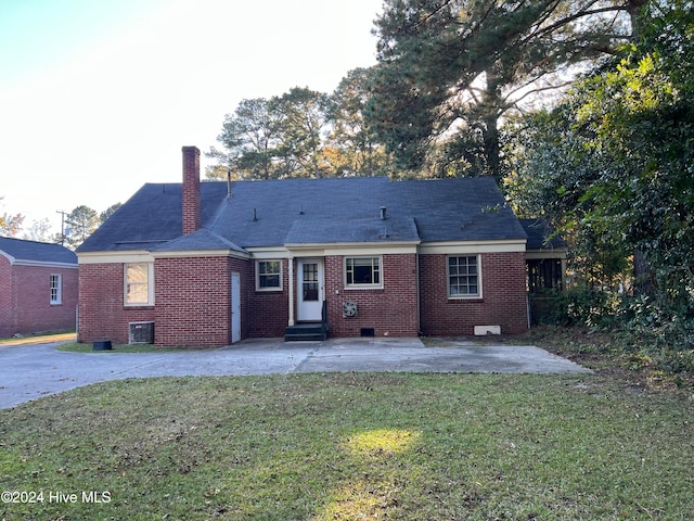 rear view of house featuring a yard and a patio area