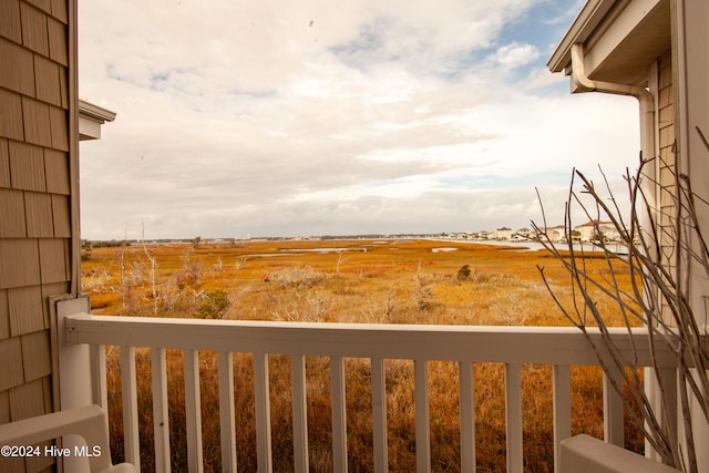 view of yard featuring a rural view and a balcony