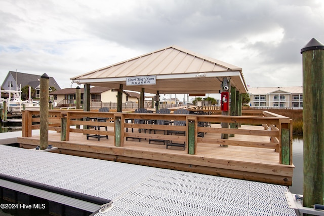 view of dock with a gazebo and a water view