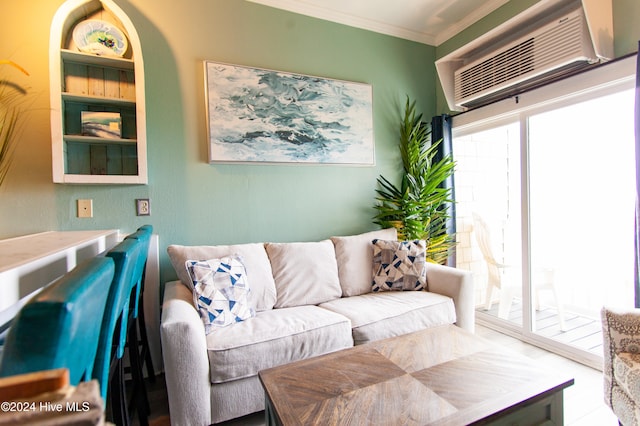 living room featuring a wall unit AC and crown molding