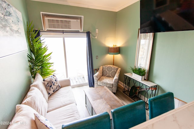 living room with a wall mounted air conditioner, hardwood / wood-style flooring, and crown molding