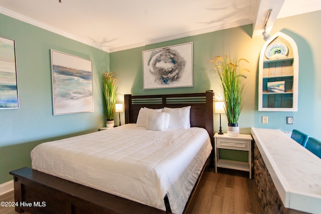 bedroom featuring crown molding and dark hardwood / wood-style flooring