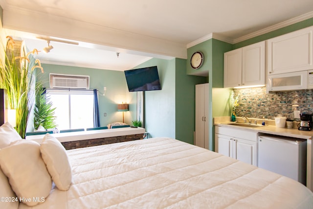 bedroom featuring an AC wall unit, sink, and ornamental molding