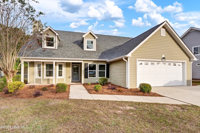 cape cod-style house with a garage, covered porch, and a front lawn