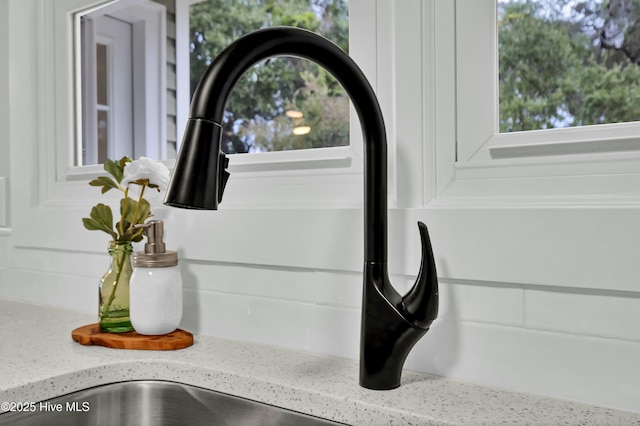 details featuring sink and light stone countertops