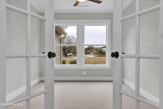 unfurnished sunroom with ceiling fan