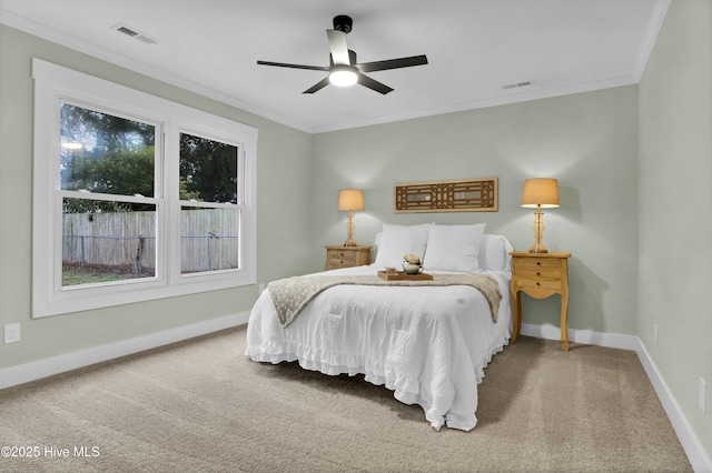 carpeted bedroom with crown molding and ceiling fan