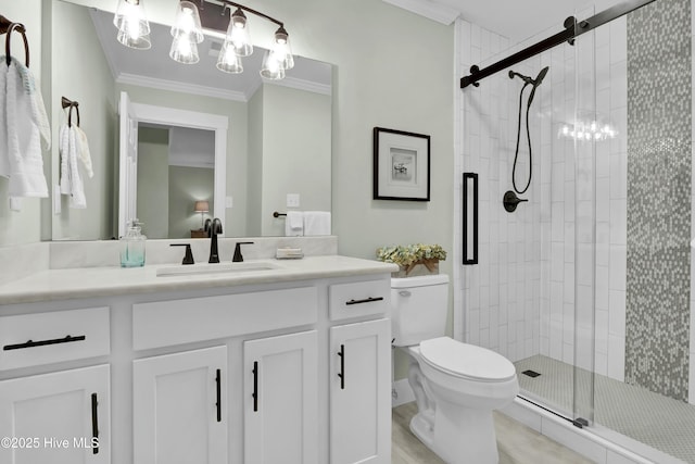 bathroom featuring crown molding, vanity, toilet, and an enclosed shower