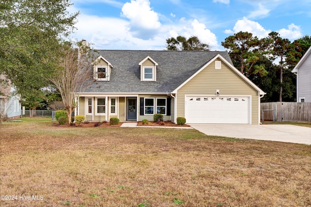 cape cod house featuring a garage and a front lawn