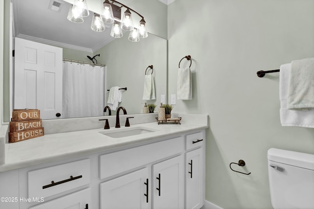 bathroom with crown molding, vanity, and toilet