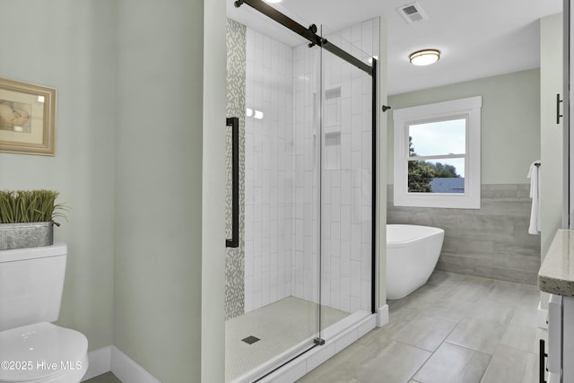 full bathroom with tile walls, vanity, shower with separate bathtub, and toilet