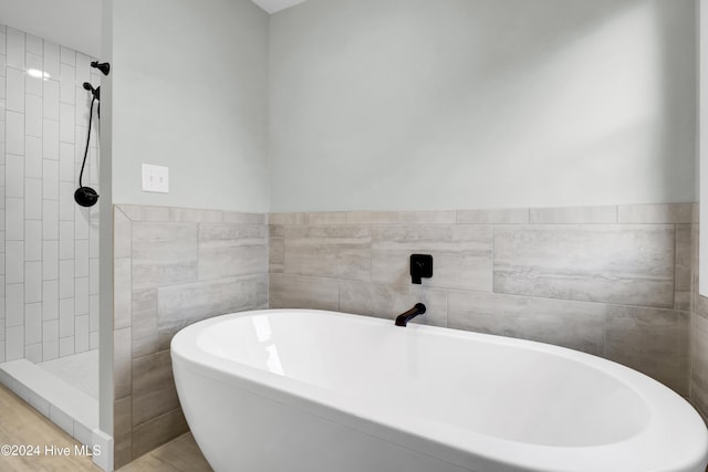 bathroom featuring separate shower and tub