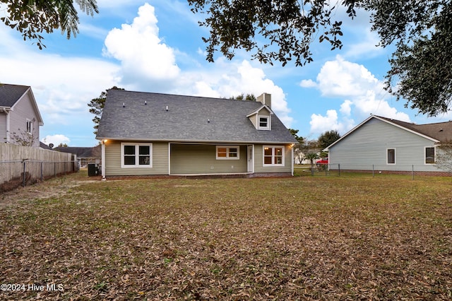 rear view of house featuring a yard