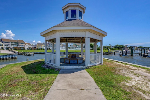 view of community featuring a yard, a gazebo, and a water view