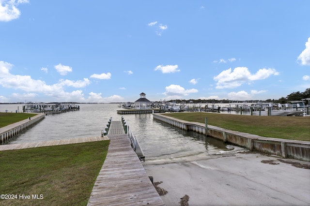 view of dock featuring a water view and a lawn