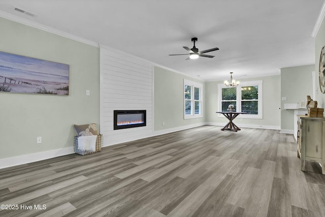 unfurnished living room featuring crown molding, a fireplace, ceiling fan with notable chandelier, and light hardwood / wood-style floors